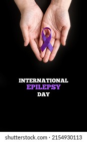 International Epilepsy Day. Woman Hands Holding Purple Ribbon On Black Background. Alzheimer's Disease, Pancreatic Cancer, Hodgkin's Lymphoma Awareness. World Lupus Day And World Cancer. Vertically