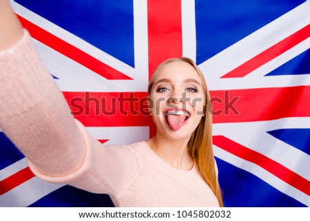 International europe style stylish people careless restless lifestyle leisure concept. Close up portrait of excited cheerful comic joking blogger demonstrating tongue taking making selfie