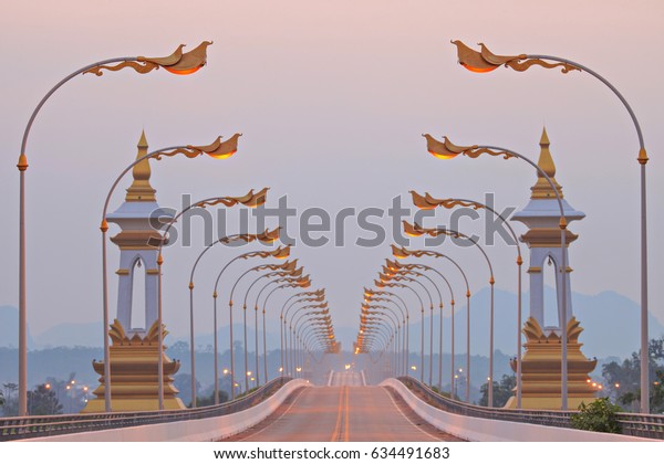 International express\
route between Thailand and Laos, Bridge over the Mekong River in\
the morning sunrise.\
