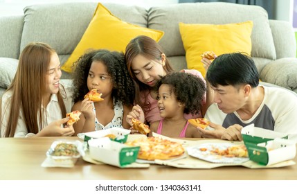 International Family Of Happy Man ,woman And Children. They Are Having Party At Home, Eating Pizza And Having Fun. Leisure, Food And Drinks, People And Holidays Concept. Ethnic Diversity,Host Family