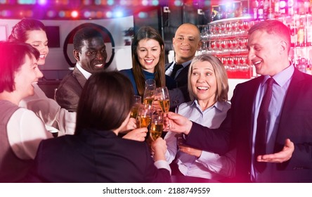 International Group Of L Positive Smiling Businesspeople Toasting With Champagne, Having Fun At Office Party In Nightclub