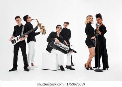 International group of musicians on a white background, guitarist, drummer, soloists, saxophonist. Copy space, relkama for musical instruments. - Powered by Shutterstock