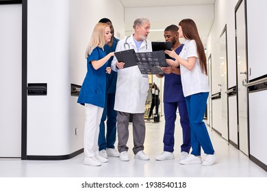 International Group Of Young Nurses Led By An Elderly Doctor - Powered by Shutterstock