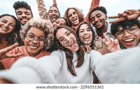 International group of young people laughing at camera outside - Happy friends taking selfie pic with smartphone device - Life style concept with guys and girls hanging out together