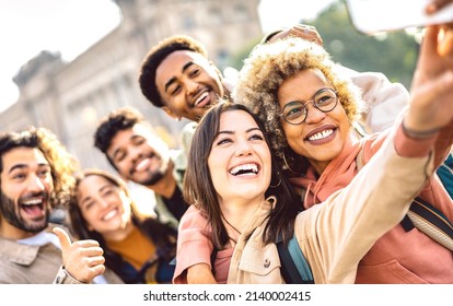 International guys and girls taking photo out side in Barcelona - Happy life style concept on young multiracial college students having fun day together at university campus - Bright faces warm filter - Shutterstock ID 2140002415