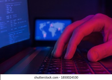 International Hacking And Worldwide Cyberterrorism Concept, Hacker Typing On Keyboard In Dark Room