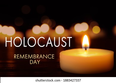 International Holocaust Remembrance Day. Burning candle on black table, closeup