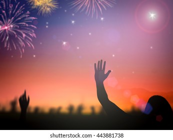 International human rights day concept: Silhouette people raising hands on blurred colorful firework background