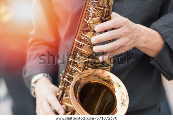 International jazz day and World Jazz festival.\
Saxophone, music instrument played by saxophonist player musician\
in fest.