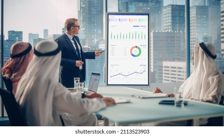 International Manager Holds Meeting Presentation For Saudi Business Partners. Specialist Uses Whiteboard With Growth Analysis, Charts, Statistics And Data. Saudi, Emirati, Arab Office Concept.