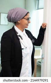 An International Medical Student Or Physician Smiles While In The Office With A Stethascope Around Her Neck 