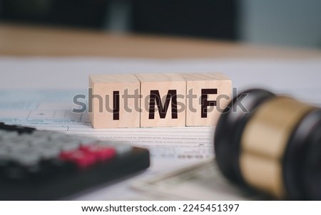 International Monetary Fund (IMF). A photograph with the word IMF on a wooden block.  And there is a calculator as an accompanying scene.