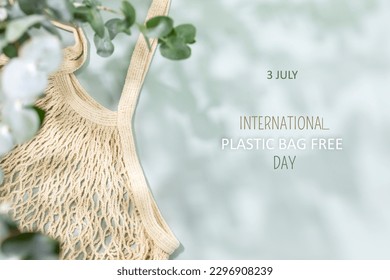 International Plastic Bag Free Day. Environment, sustainable composition with natural textile bag on blue background with green leaves and shadows and text 3 July, International Plastic Bag Free Day - Powered by Shutterstock