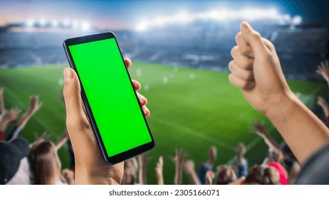 International Soccer Football Championship on Stadium: Fan on Tribune Holding Smartphone With Green Screen Chromakey Display, Cheering for Favourite Team. Isolated POV Close-Up Copyspace Template - Powered by Shutterstock