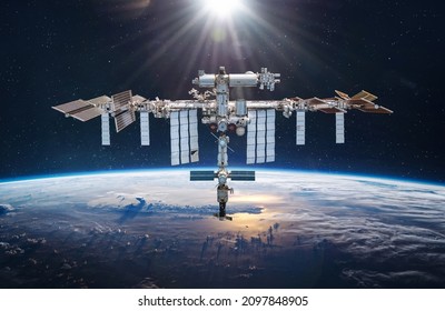 International space station in 2021 in space on orbit of Earth planet. Soyuz spacecraft on ISS. View on surface of planet. Elements of this image furnished by NASA - Powered by Shutterstock