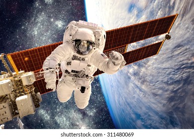 International Space Station And Astronaut In Outer Space Over The Planet Earth. Elements Of This Image Furnished By NASA.