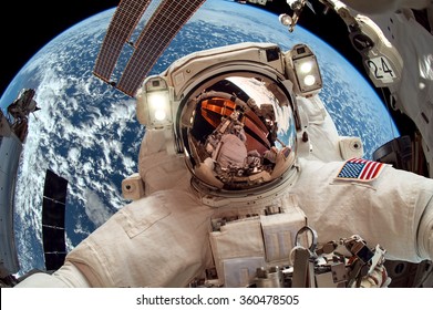 International Space Station And Astronaut In Outer Space Over The Planet Earth. Elements Of This Image Furnished By NASA.