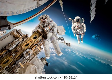 International Space Station And Astronaut In Outer Space Over The Planet Earth. Elements Of This Image Furnished By NASA.