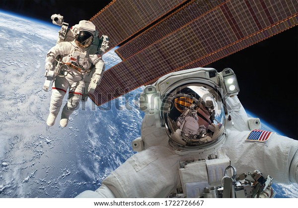 International\
Space Station and astronaut in outer space over the planet Earth.\
Elements of this image furnished by\
NASA.
