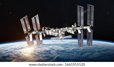 International space station on orbit of Earth planet. ISS. Dark background. Sun reflection. Elements of this image furnished by NASA