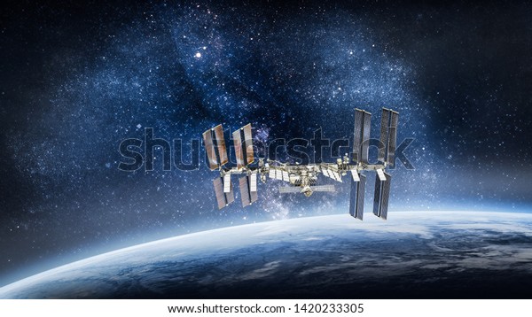 International\
space station on orbit of Earth planet. ISS. Stars and galaxies.\
Elements of this image furnished by\
NASA