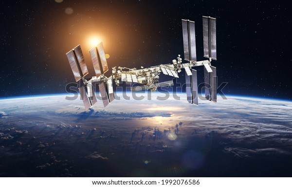 International space station on\
orbit of Earth planet. ISS. Sunlight on background. Surface of\
Earth. Sci-fi wallpaper. Elements of this image furnished by\
NASA