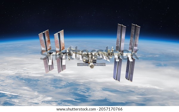 International space station on orbit of\
the Earth planet. View from outer space.ISS. Earth with clouds and\
blue sky. Elements of this image furnished by\
NASA