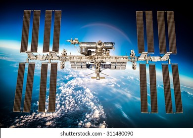 International Space Station over the planet earth. Elements of this image furnished by NASA.