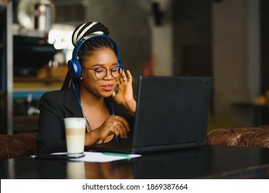 International Student Girl Is Coworking On The New Project By Chatting Online On A Portable Computer Connected To The Public Wifi Network. Freelancer Female Is Working On A Laptop.