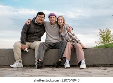 International Students Are Together On Green Campus Lawn - Group Of High School Teens Studying Outside College - Multiethnic Millenial Friends Spend Free Time Together. 