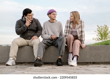 International Students Are Together On Green Campus Lawn - Group Of High School Teens Studying Outside College - Multiethnic Millenial Friends Spend Free Time Together. 