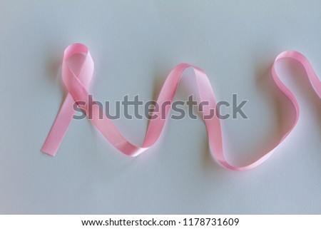International symbol of Breast Cancer Awareness Month in October. Top View Pink ribbon on white backgound. Woman Healthcare and World cancer day concept. Copy Space.
