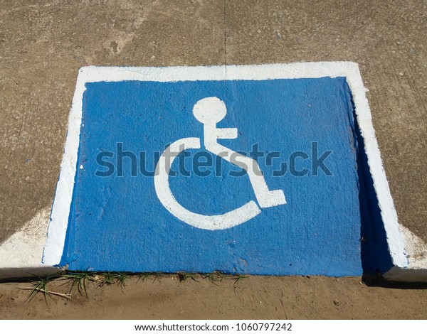 International symbol for wheelchair users\
designed on\
sidewalk