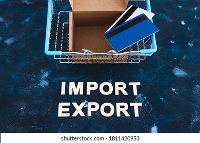 International Trade And Global Business Concept, Import Export Text Next To Shopping Basket With Open Parcel Box And Credit Cards