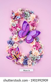 International Women's Day. Banner, Flyer, Beautiful Postcard For March 8. Flowers And Butterflies In The Shape Of The Number Eight On A Pink Background.