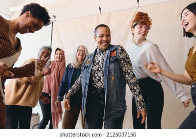 International Women's Day Candid Portrait Of Multi-ethnic, Mixed Age Range Women Dancing