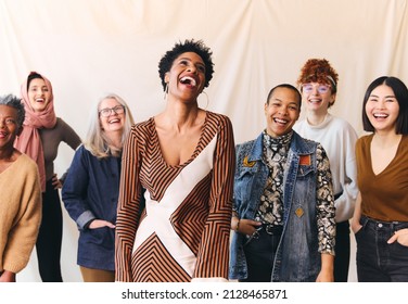 International Women's Day portrait of cheerful multi ethnic mixed age range women laughing and smiling