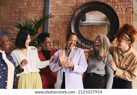 International Women's Day portrait of cheerful multiethnic mixed age range businesswomen celebrating, Embrace Equity