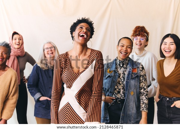 International Women's Day portrait
of cheerful multi ethnic mixed age range women laughing and
smiling