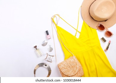 International Womens Day Sale. Woman Clothes & Accessories, Spring Summer Collection. Yellow Dress, Straw Hat & Shoulder Bag, Brown Sunglasses Eyewear. Boho Chic Style Aluminum Earrings. Flat Lay.