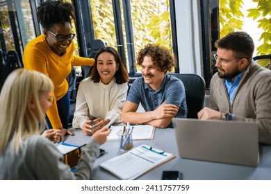 International workers group and team leader having teamwork discussion managing project at work in meeting room. - Powered by Shutterstock