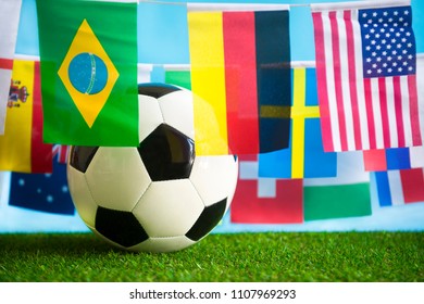 International World Flag Bunting Hanging Around A Football Sitting On Grass 