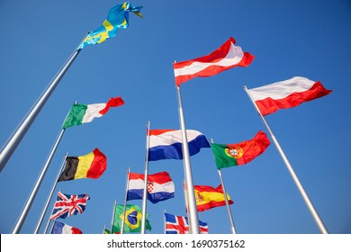 Internationals flag on top of pole with blue sky background that flags swaying in wind.