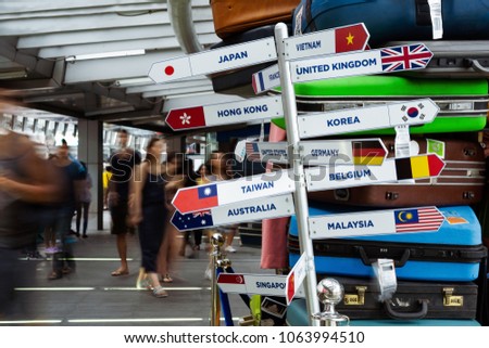 internationnal global flag signs with blured motion crowded people.