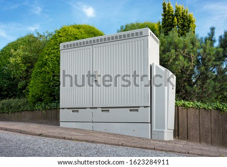 Internet cable distributor box DSL on sidewalk low angle view