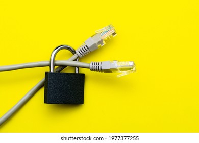 Internet Cable Passing Through A Closed Iron Lock On A Yellow Background Data Protection Concept. High Quality Photo