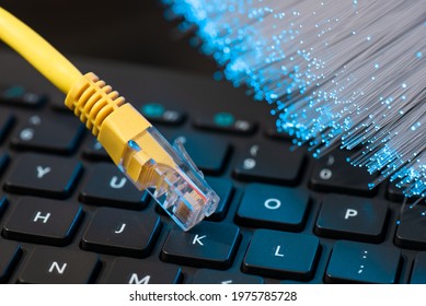 Internet Cable, RJ-45 Plug On Laptop Keyboard. High Speed Fiber Optic Internet Concept