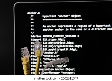 Internet Cables And World Wide Web Source Code Which Was Sold As NFT By Tim Berners Lee Seen On The Blurred Background Screen. Concept. Stafford, UK, July 1, 2021
