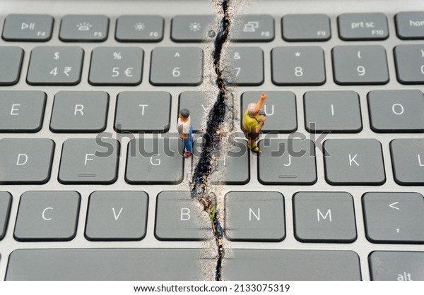 Internet\
Confrontation.digital divide.The keyboard is split by the cracks\
that separate the opposites.Social Divide.Divided\
world.conflicts.cyberbullying.