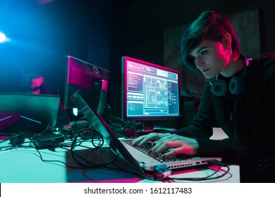 Internet fraud, darknet, data thiefs, cybercrime. Hacker attack on government server. Dangerous criminals coding virus programs in the basement.